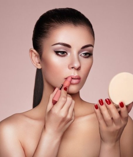 beautiful-woman-paints-lips-with-lipstick